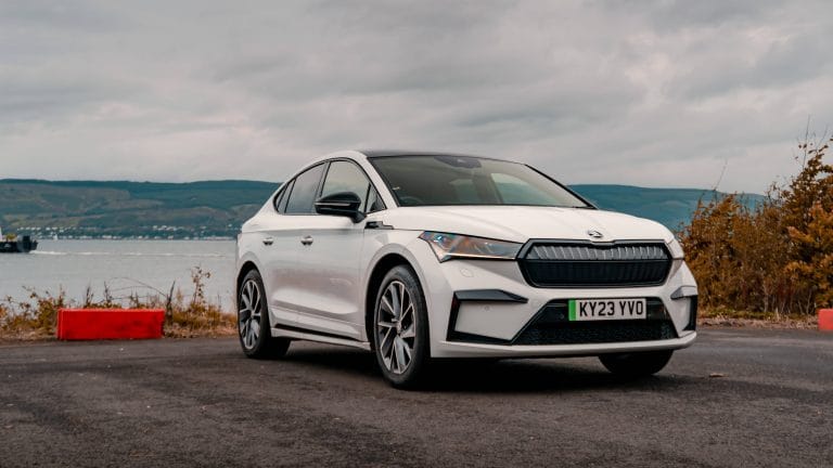 Moon White Skoda Enyaq coupe Sportline Plus photographed in front of water