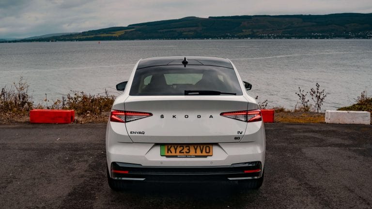 Rear view of Skoda Enyaq Coupe in facing water