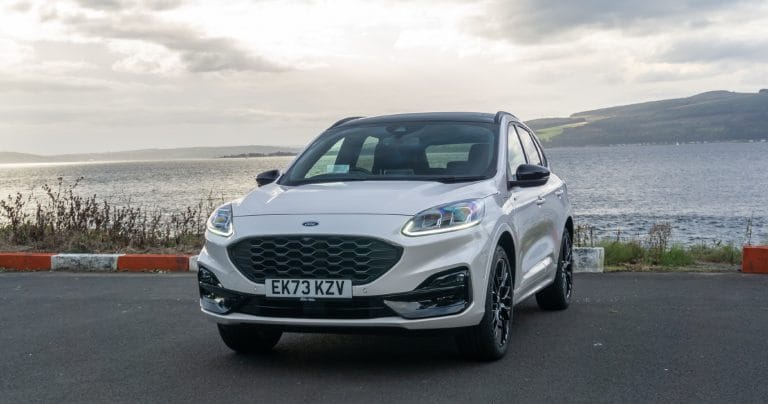 Ford Kuga plug-in hybrid parked in front of water