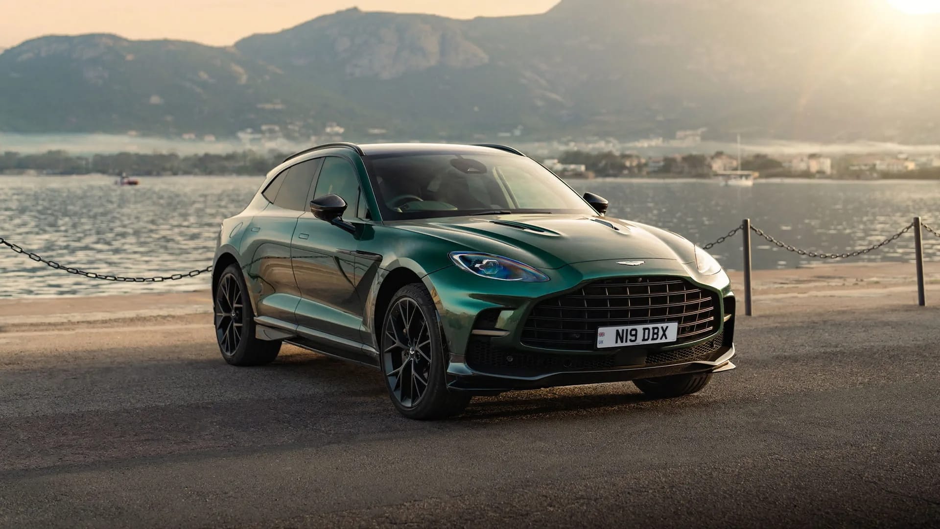 Photo of British Racing Green Aston Martin DBX parked by the sea
