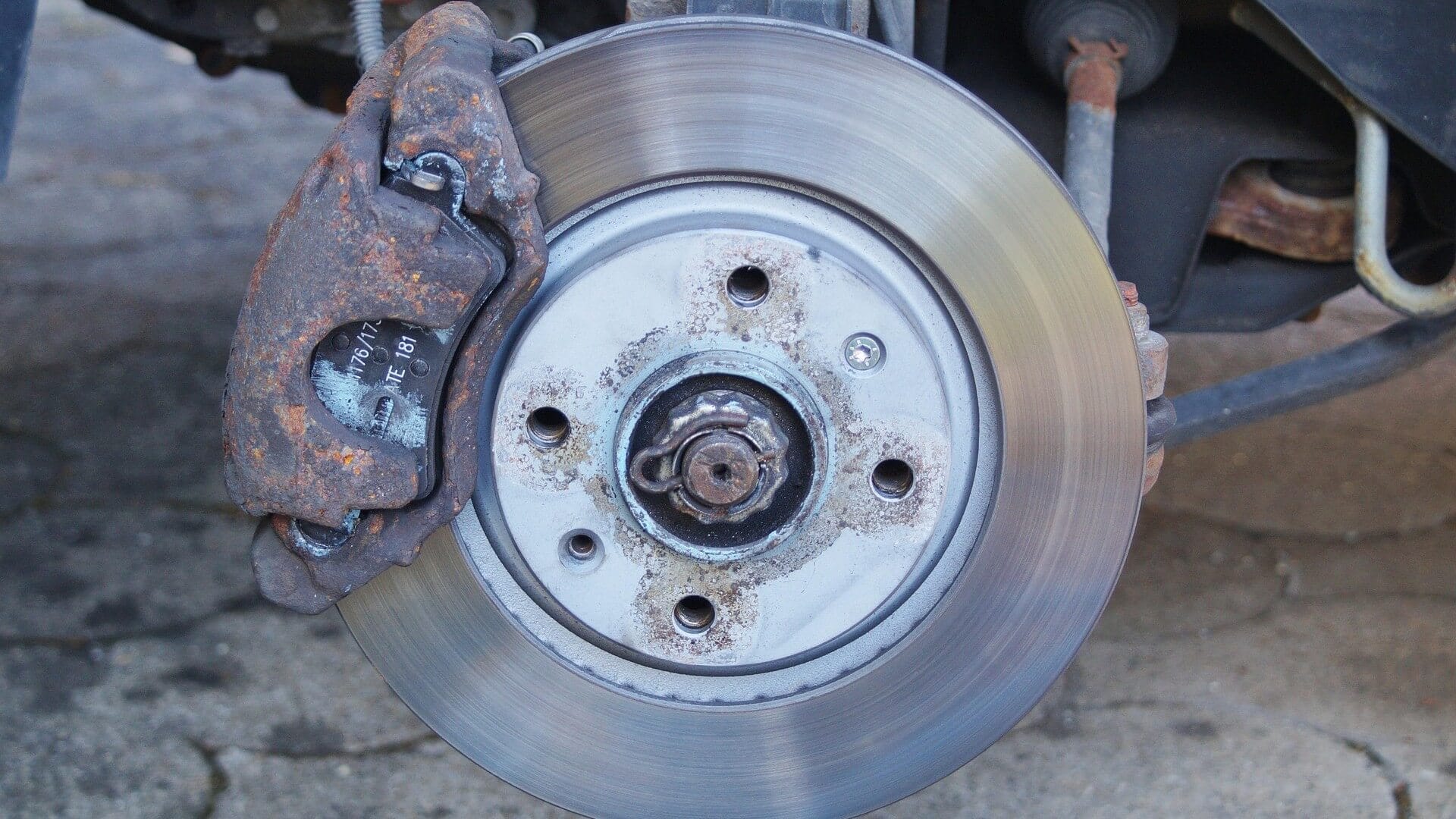 Image of a brake disc and pad on a car.