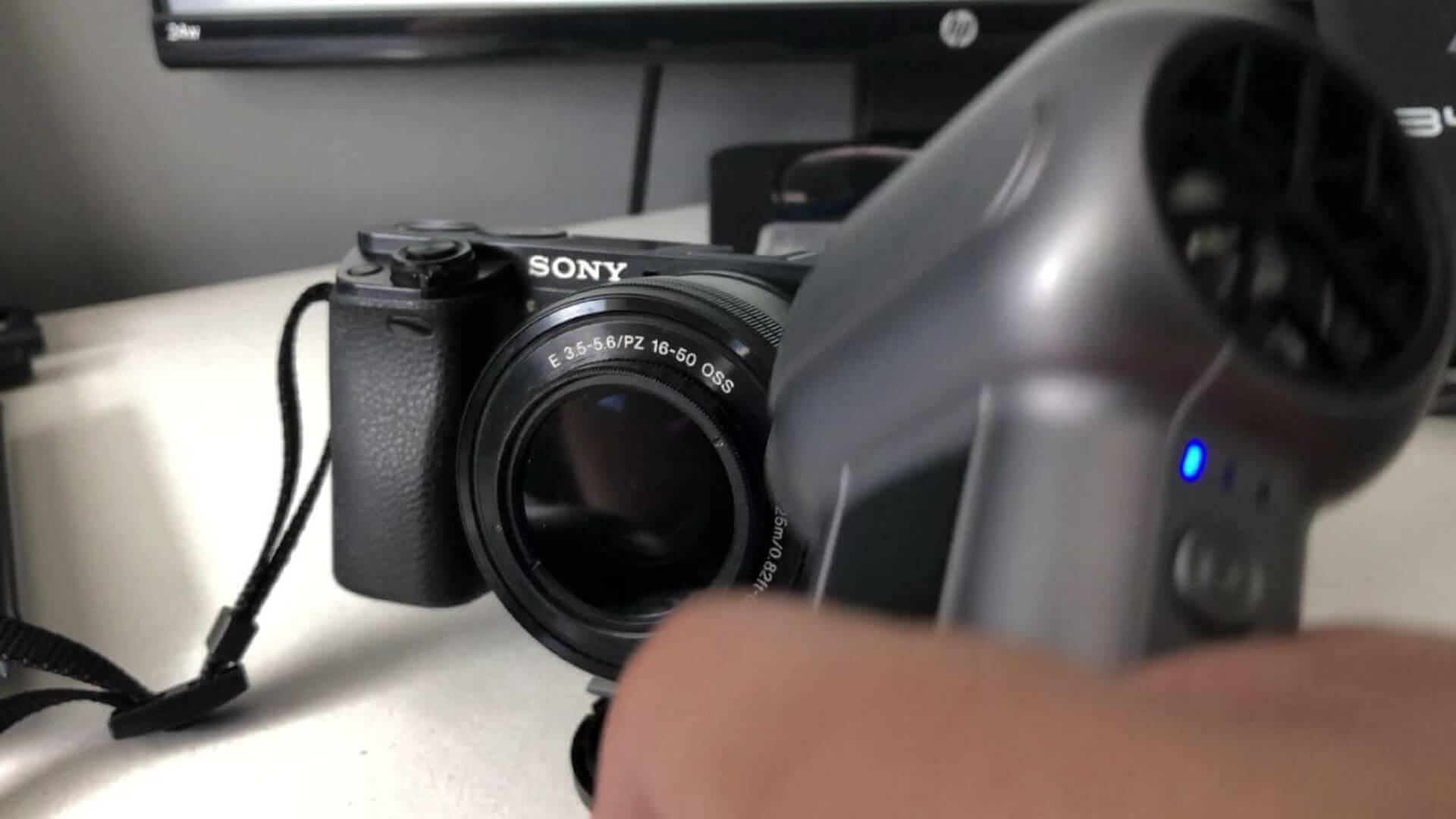 Removing dust from camera lens with duster.