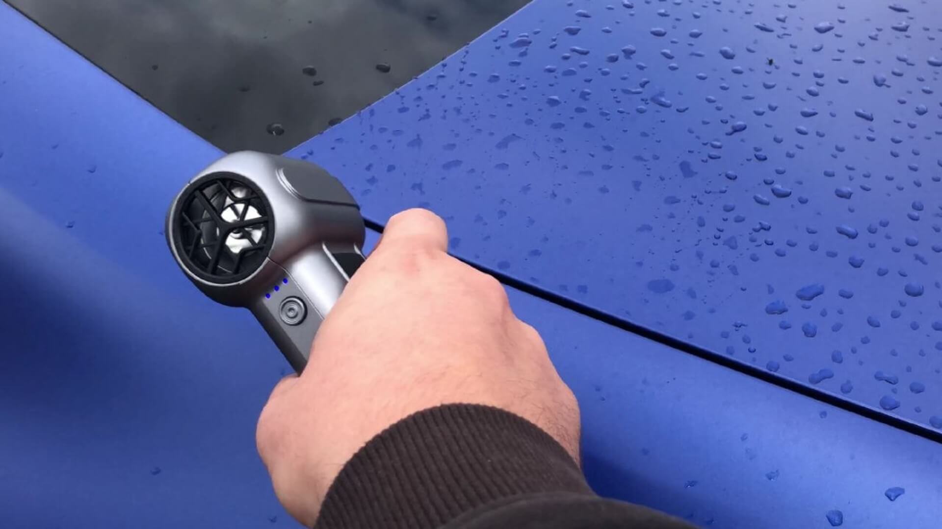 Image of Dylan blow-drying a BMW with the Wolfbox air duster.