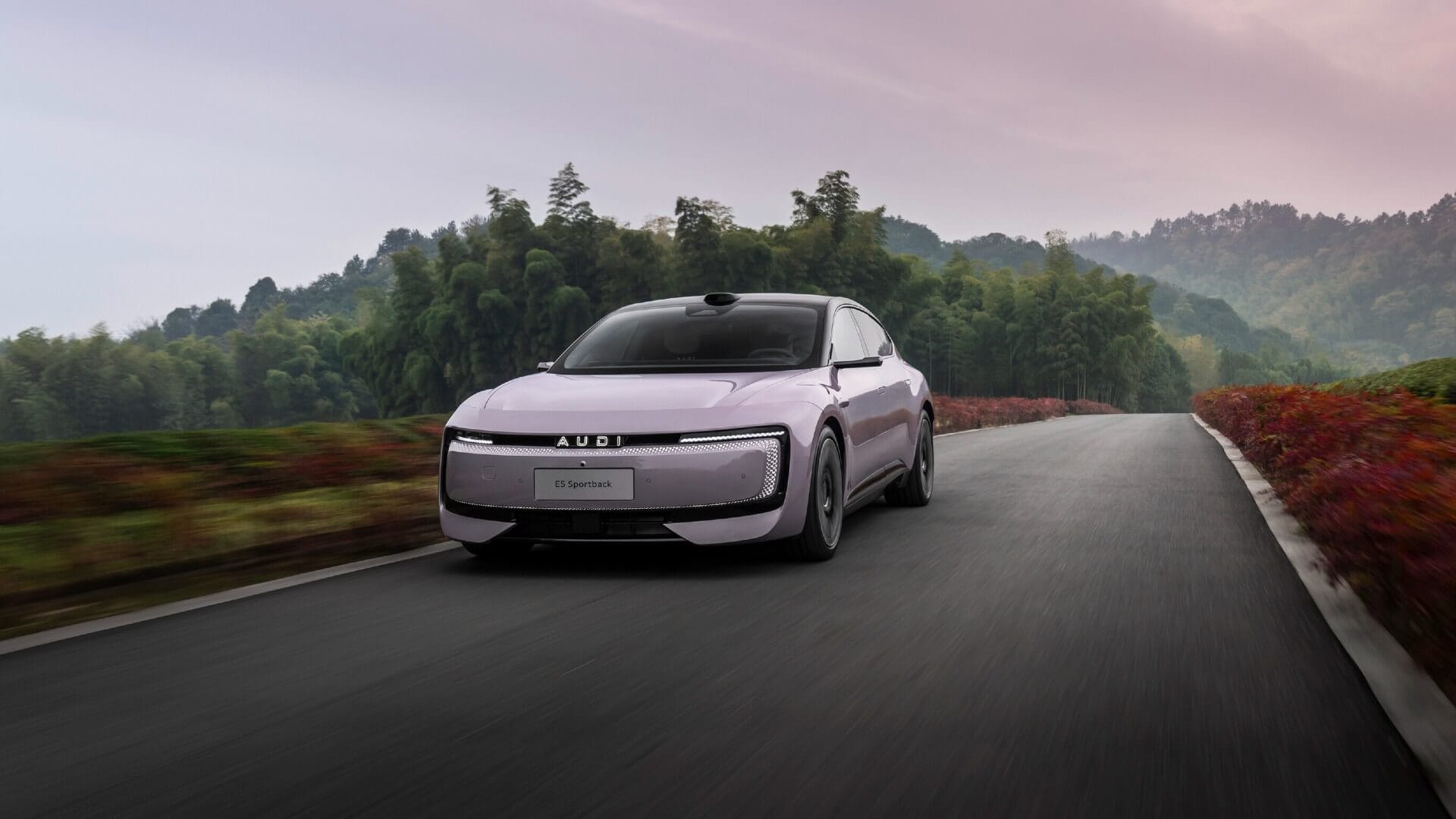 Photo of the AUDI E5 driving along a country road.