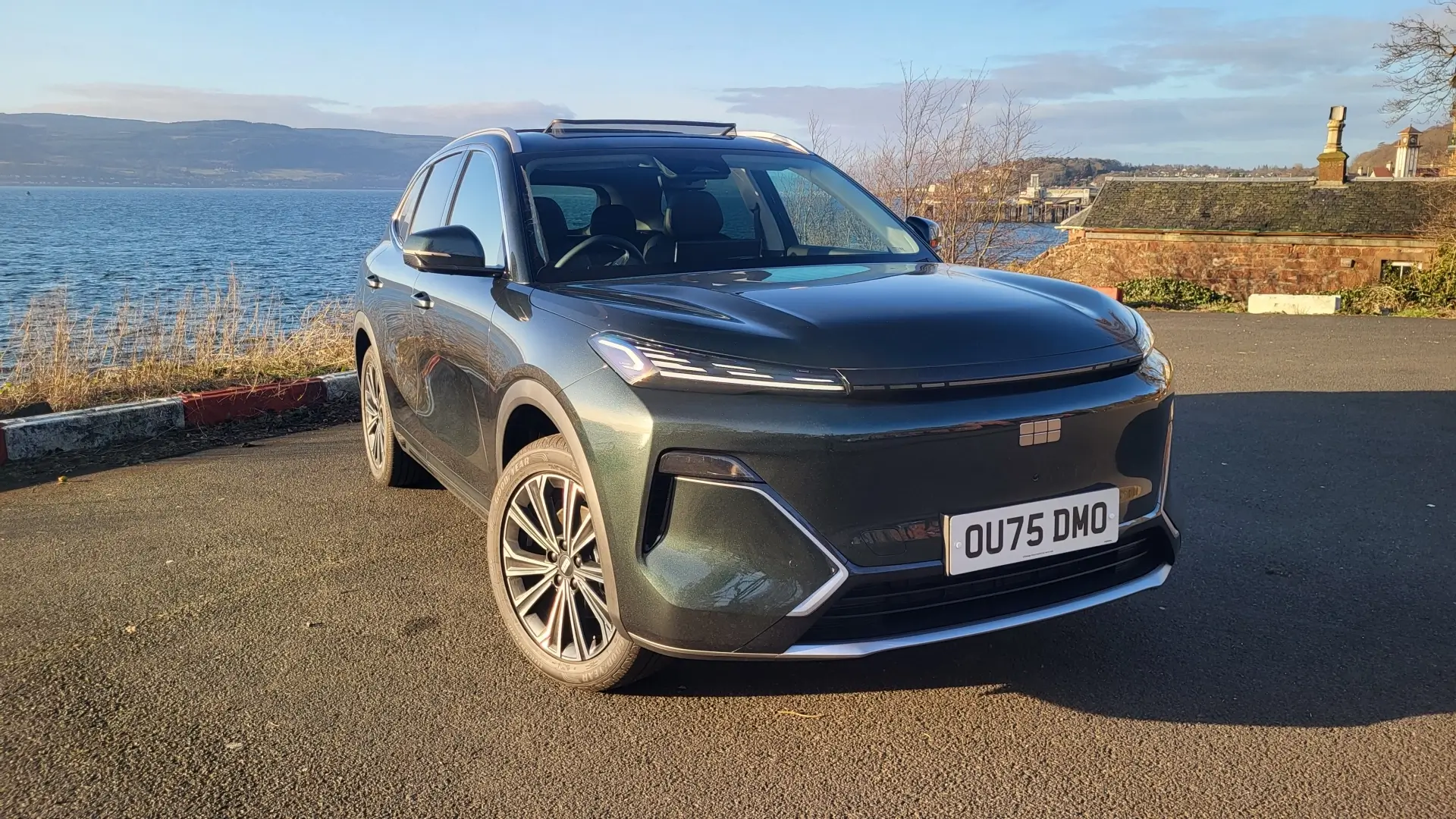 photo of the 2026 Geely Starray EM-i parked in front of river at sunset.